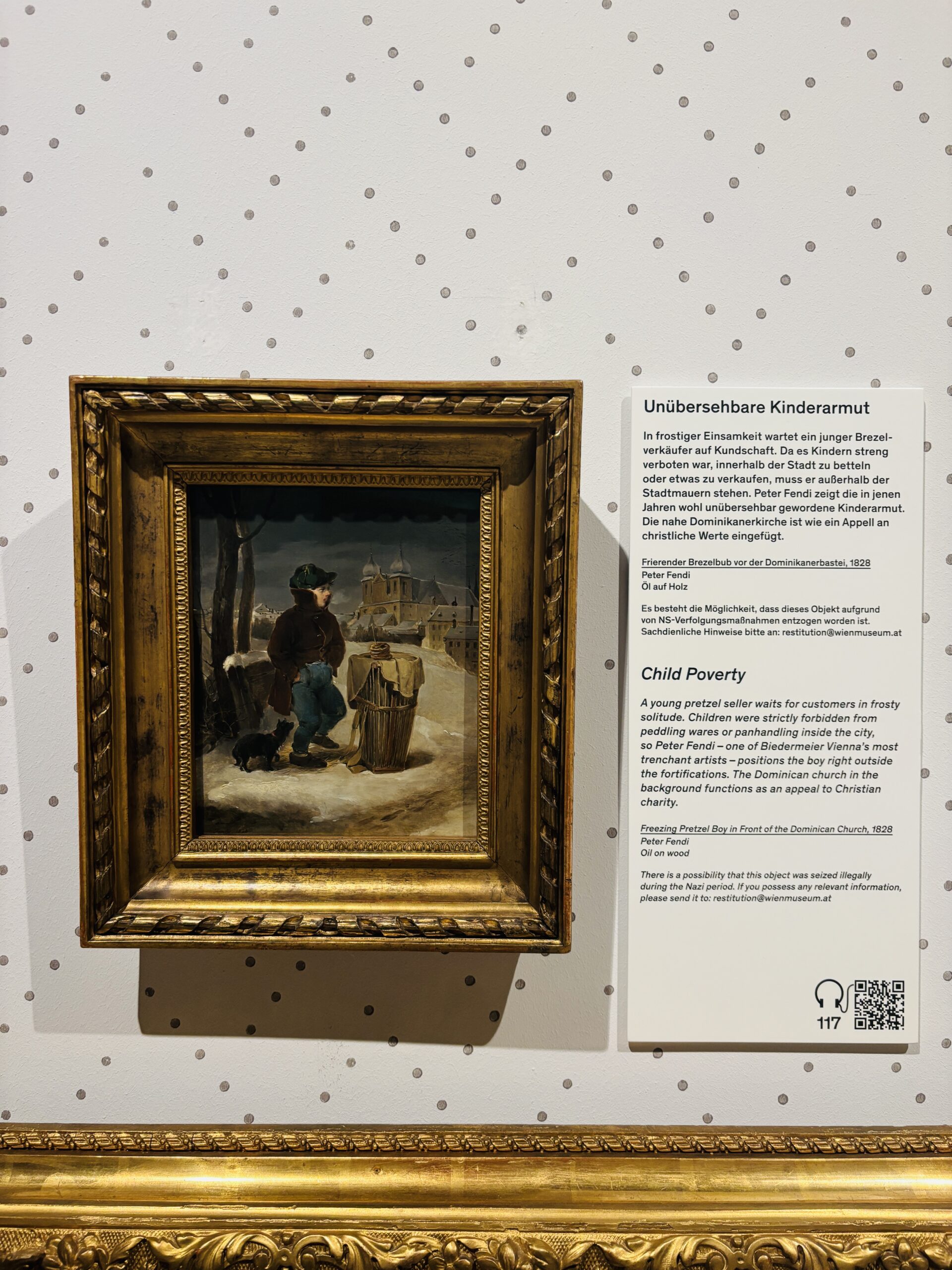 Oil painting by Peter Fendi titled “Freezing Pretzel Boy in front of the Dominican Church ” showing a poor young boy in 19th-century Vienna, once looted by the Nazis and now held at the Wien Museum.