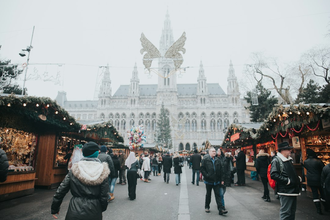 Visitors walking through a festive Christmas market in Vienna, Austria